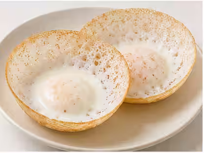 A bowl-shaped hopper with a fried egg in the centre